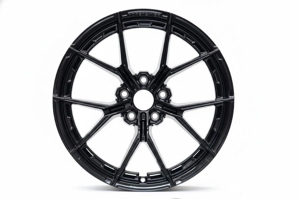 Gloss black WWC VFX Split-Spoke Flow-Form Wheel by WheelWorkCustoms, showcasing its sleek, modern design and detailed spoke pattern.